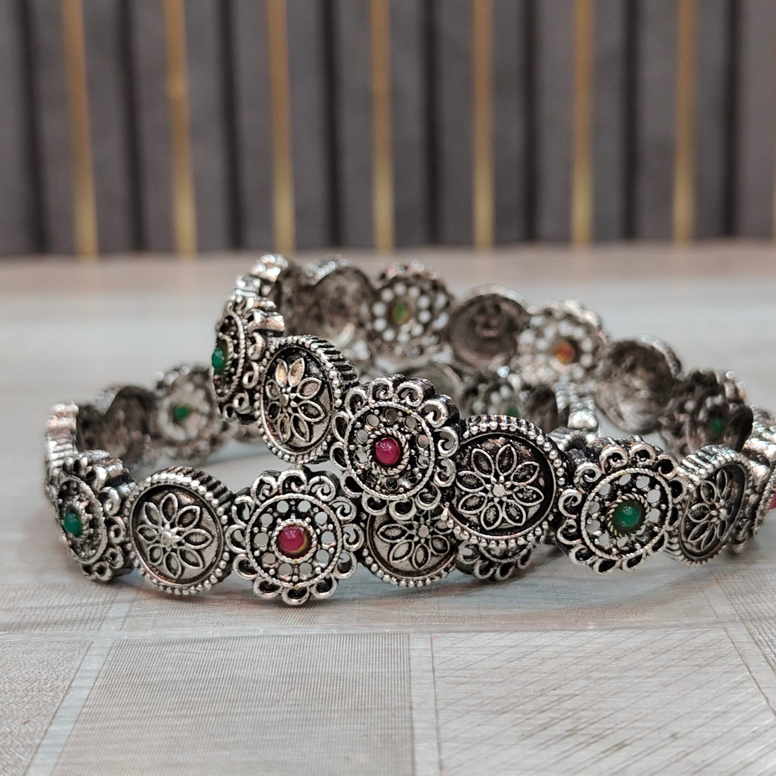 Antique Oxidized Silver Floral Round Motif Bangles with Red & Green Stone Accents - Image 3