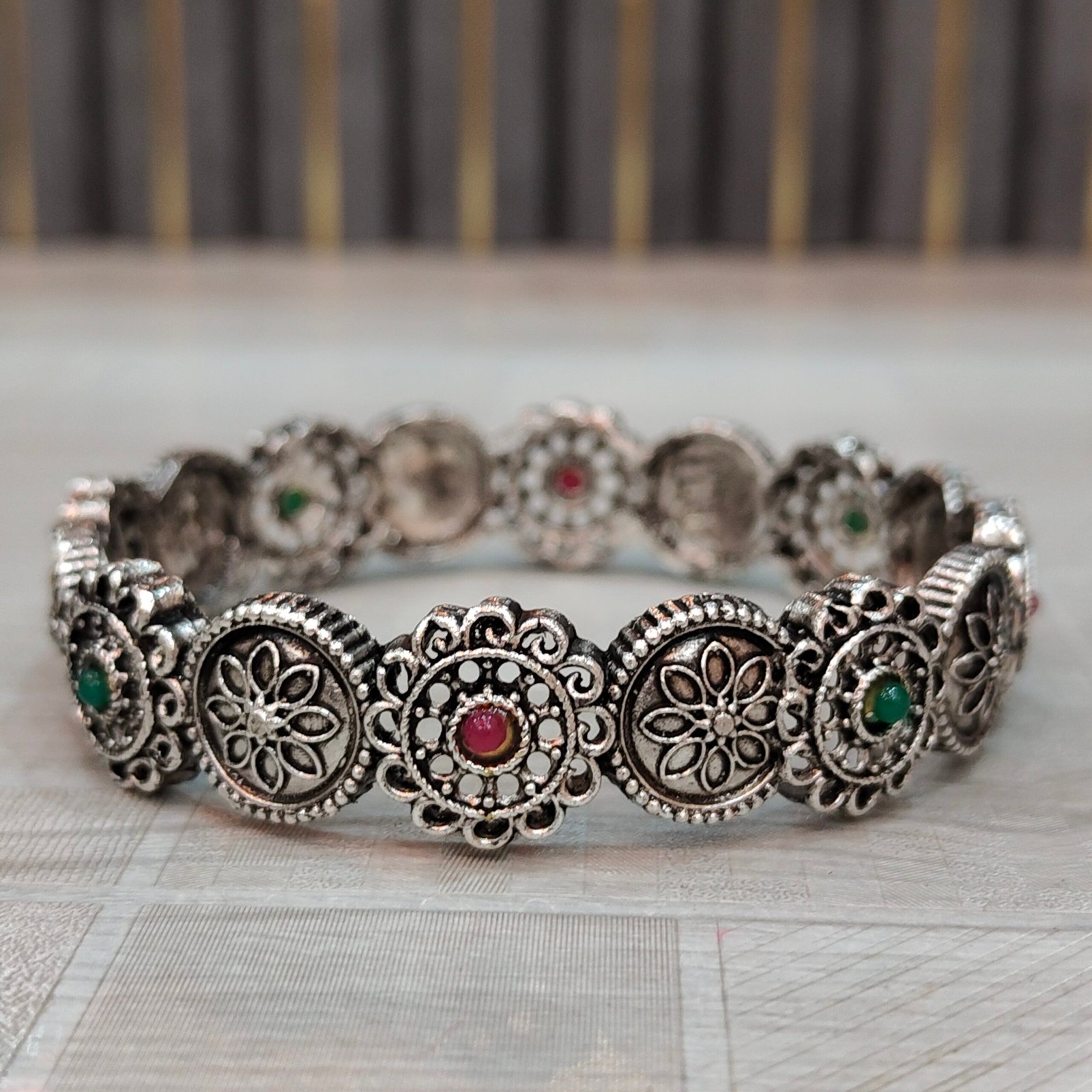 Antique Oxidized Silver Floral Round Motif Bangles with Red & Green Stone Accents - Image 2